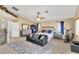 Spacious main bedroom featuring a ceiling fan, couch, wardrobe, and ensuite bathroom at 41 Stablewood Ct, North Las Vegas, NV 89084