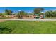 Community playground featuring slides, covered picnic area, and green grass for enjoyment at 41 Stablewood Ct, North Las Vegas, NV 89084