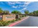 Community entrance sign for Harmony Pointe, set against a backdrop of lush landscaping and a blue sky at 41 Stablewood Ct, North Las Vegas, NV 89084