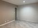 Neutral bedroom with large tile flooring, base trim, and an open door frame at 461 N Lamb Blvd # H, Las Vegas, NV 89110