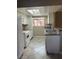 Galley kitchen featuring white appliances, granite countertops, and a window overlooking the exterior at 461 N Lamb Blvd # H, Las Vegas, NV 89110