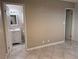 View into the main bedroom suite with en-suite bath, tiled floors, and neutral paint at 461 N Lamb Blvd # H, Las Vegas, NV 89110