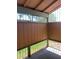 The patio has a covered enclosure with view of the lawn and nearby greenery for a private outdoor escape at 461 N Lamb Blvd # H, Las Vegas, NV 89110