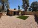 View of a backyard with modern landscaping, a patio, and a fenced perimeter for privacy at 5653 White Cap St, Las Vegas, NV 89110