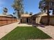 Cozy backyard featuring a small patio, fenced yard, and decorative rock landscaping at 5653 White Cap St, Las Vegas, NV 89110