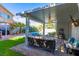 Lovely backyard featuring a pool, covered patio, and lush greenery at 7800 Four Seasons Dr, Las Vegas, NV 89129