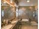 Lavish bathroom featuring double sinks, soaking tub, and glass shower at 7800 Four Seasons Dr, Las Vegas, NV 89129
