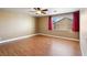 Spacious bedroom with wood floors, a ceiling fan, and a large window at 7800 Four Seasons Dr, Las Vegas, NV 89129