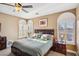 Sunlit primary bedroom features plush carpet, ceiling fan, and shuttered windows at 7800 Four Seasons Dr, Las Vegas, NV 89129