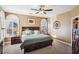 Sunlit primary bedroom features plush carpet, ceiling fan, and shuttered windows at 7800 Four Seasons Dr, Las Vegas, NV 89129