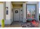 Charming front entrance featuring a decorative wreath, desert plants, and stylish exterior lighting at 7800 Four Seasons Dr, Las Vegas, NV 89129