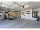 Organized garage with ample space for parking and storage, including a treadmill and bike at 7800 Four Seasons Dr, Las Vegas, NV 89129
