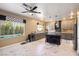 The spacious kitchen features an island, granite countertops, and a view of the backyard pool at 7800 Four Seasons Dr, Las Vegas, NV 89129