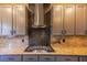 Modern kitchen with granite countertops, stainless steel range hood, and custom cabinets at 7800 Four Seasons Dr, Las Vegas, NV 89129