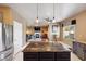 Open-concept kitchen view features a large island, stainless steel appliances, and a glimpse into the living room at 7800 Four Seasons Dr, Las Vegas, NV 89129