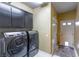 Laundry room with modern washer and dryer and convenient cabinets at 7800 Four Seasons Dr, Las Vegas, NV 89129