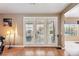Living room area with wood floors, bright natural light, and glass doors to the backyard at 7800 Four Seasons Dr, Las Vegas, NV 89129