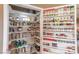 Walk-in pantry with custom shelving, organized storage for spices, jars, and other food items at 7800 Four Seasons Dr, Las Vegas, NV 89129