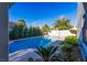 Beautiful in-ground swimming pool surrounded by lush landscaping at 7800 Four Seasons Dr, Las Vegas, NV 89129