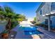 Beautiful in-ground pool and spa surrounded by lush landscaping at 7800 Four Seasons Dr, Las Vegas, NV 89129