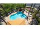 Aerial view of a resort-style pool featuring abundant seating, palm trees, and a shaded pergola at 8541 Heather Downs Dr, Las Vegas, NV 89113