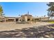 Stately clubhouse with circular drive and well-manicured desert landscaping and palm trees at 8541 Heather Downs Dr, Las Vegas, NV 89113