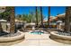 Relaxing hot tub area with lounge chairs, decorative palms, and privacy walls at 8541 Heather Downs Dr, Las Vegas, NV 89113