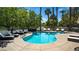 Community pool area with lounge chairs and lush landscaping for a resort-like experience at 8541 Heather Downs Dr, Las Vegas, NV 89113