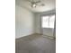 Carpeted bedroom with a ceiling fan and natural lighting at 855 N Stephanie St # 112, Henderson, NV 89014