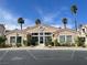 Community clubhouse boasts desert landscaping, palms, and covered parking at 855 N Stephanie St # 112, Henderson, NV 89014