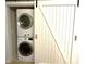 Laundry closet with a stackable washer and dryer and a barn door at 855 N Stephanie St # 112, Henderson, NV 89014