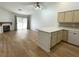 Open concept living room features wood floors, a fireplace, and access to the patio at 855 N Stephanie St # 112, Henderson, NV 89014