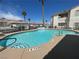 Sparkling community pool with lounge area surrounded by lush landscaping at 855 N Stephanie St # 112, Henderson, NV 89014