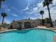 Community pool area with ample deck space and desert landscaping at 855 N Stephanie St # 112, Henderson, NV 89014