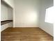 Bright room with wood floors, a built-in desk, and natural light at 855 N Stephanie St # 112, Henderson, NV 89014