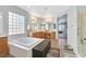 Luxurious bathroom featuring a soaking tub, dual vanities, and a walk-in shower at 8828 Monte Oro Dr, Las Vegas, NV 89131