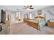 Bright bedroom with neutral walls, carpet, ceiling fan and well-coordinated furnishings at 8828 Monte Oro Dr, Las Vegas, NV 89131