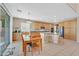 Eat-in kitchen featuring wood cabinets, tile floors, an island, and a sliding glass door at 8828 Monte Oro Dr, Las Vegas, NV 89131