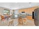 Kitchen with maple cabinets, a center island with seating, and stainless steel appliances at 8828 Monte Oro Dr, Las Vegas, NV 89131