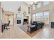 Spacious living room with a fireplace, tall windows, and comfortable seating at 8828 Monte Oro Dr, Las Vegas, NV 89131
