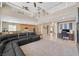 Open-concept living space featuring a fireplace, tall ceilings, and a view of the kitchen at 8828 Monte Oro Dr, Las Vegas, NV 89131