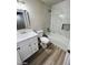 Modern bathroom with shower and tub combo with stylish vanity and mirror at 124 Winley Chase Ave, North Las Vegas, NV 89032