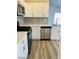 Well-lit kitchen features stainless steel appliances, white cabinets, and modern backsplash at 124 Winley Chase Ave, North Las Vegas, NV 89032