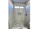 White marble tiled shower with a mosaic tile floor and window at 124 Winley Chase Ave, North Las Vegas, NV 89032