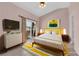 Comfortable bedroom featuring a modern bed, dresser, and access to a balcony at 2001 Quarry Ridge St # 207, Las Vegas, NV 89117