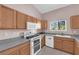Bright kitchen features modern appliances, tile flooring, and a window with a pleasant view at 2001 Quarry Ridge St # 207, Las Vegas, NV 89117