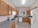 Well-lit kitchen features stainless steel appliances, ample counter space, and wood cabinets at 2001 Quarry Ridge St # 207, Las Vegas, NV 89117