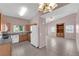 Open kitchen and living room layout featuring a large refrigerator and spacious living area at 2001 Quarry Ridge St # 207, Las Vegas, NV 89117