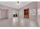 Bright living room featuring tile flooring, built-in shelving, and a sliding glass door to the outside at 2001 Quarry Ridge St # 207, Las Vegas, NV 89117