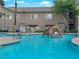 Community pool featuring a rock waterfall with surrounding apartment buildings at 2001 Quarry Ridge St # 207, Las Vegas, NV 89117